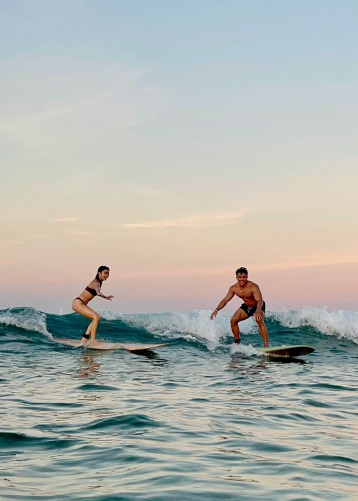Group relaxing at the beach after surfing